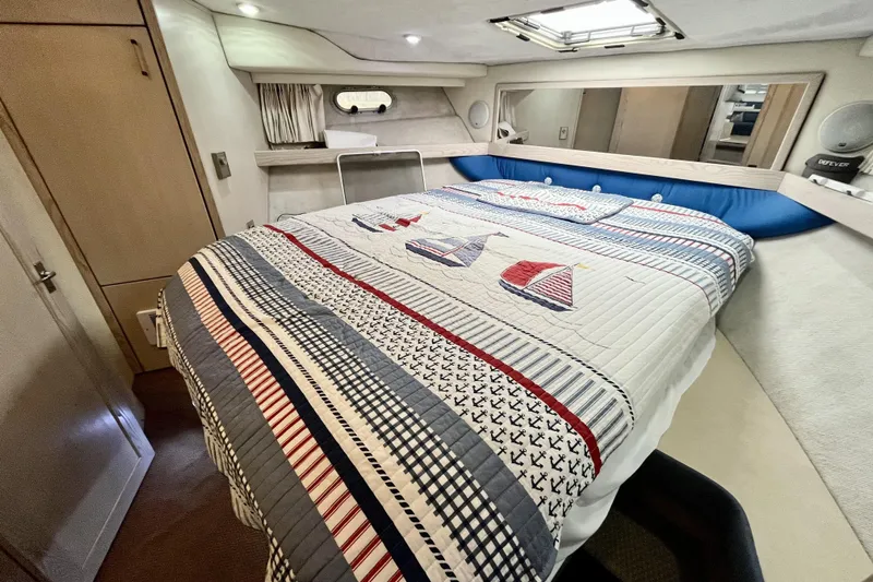  Yacht Photos Pics Cozy bedroom in 1996 Bayliner 3988 Motoryacht with nautical-themed bedding.