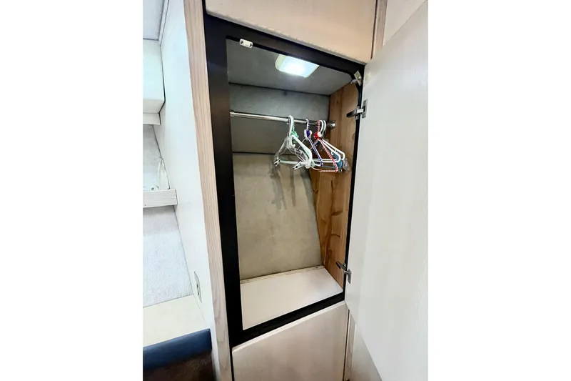  Yacht Photos Pics Open closet with hangers inside a 1996 Bayliner 3988 Motoryacht.