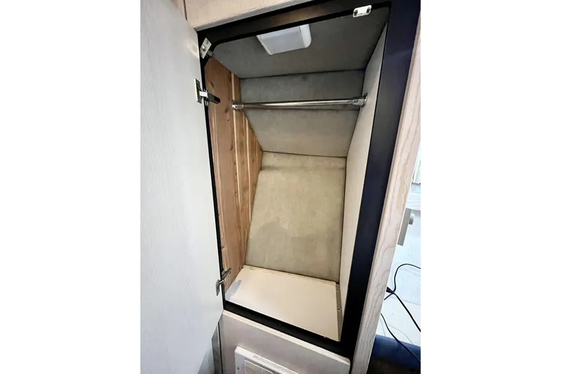  Yacht Photos Pics Interior closet of 1996 Bayliner 3988 Motoryacht with hanging rod and light.