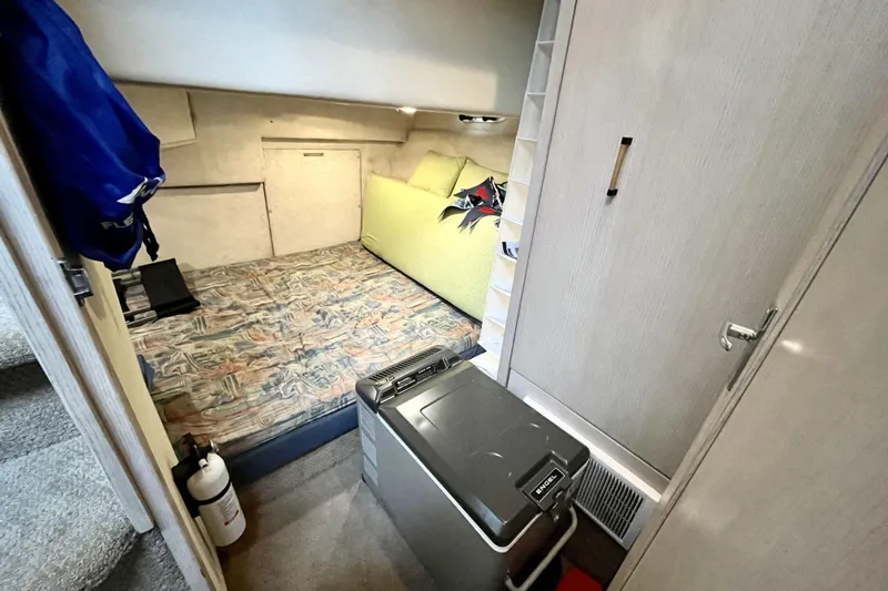  Yacht Photos Pics Interior cabin of 1996 Bayliner 3988 Motoryacht with bed, storage, and compact design.