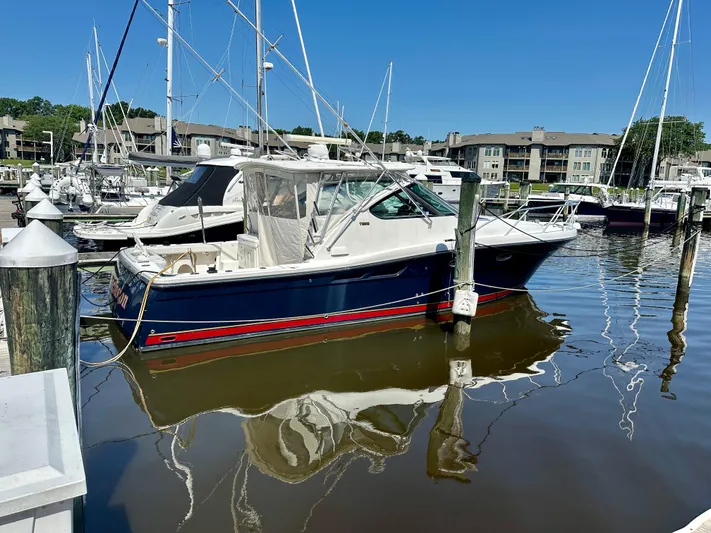  Yacht Photos Pics 2005 Tiara Yachts 3600 Open docked at marina, clear blue sky, calm water reflections.
