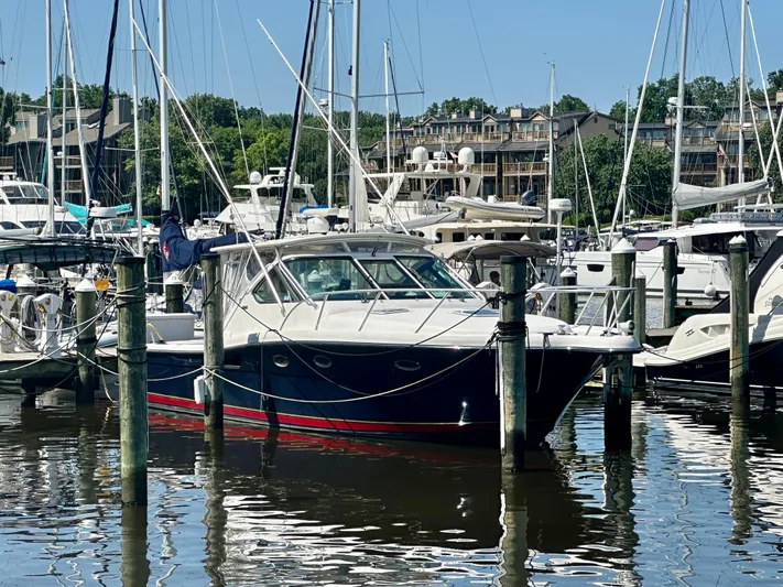  Yacht Photos Pics 2005 Tiara Yachts 3600 Open docked in a marina, surrounded by other boats.