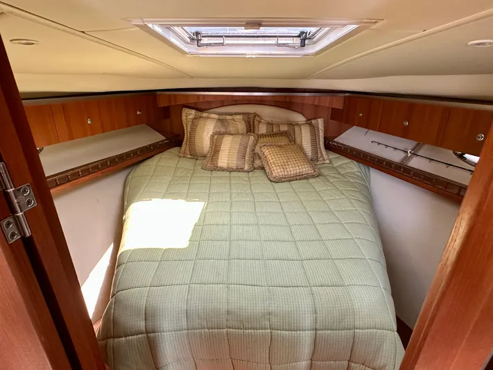  Yacht Photos Pics 2005 Tiara Yachts 3600 Open cabin with cozy bed and wooden cabinetry.