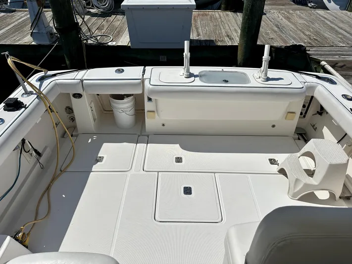  Yacht Photos Pics 2005 Tiara Yachts 3600 Open boat deck with fishing setup and storage compartments.