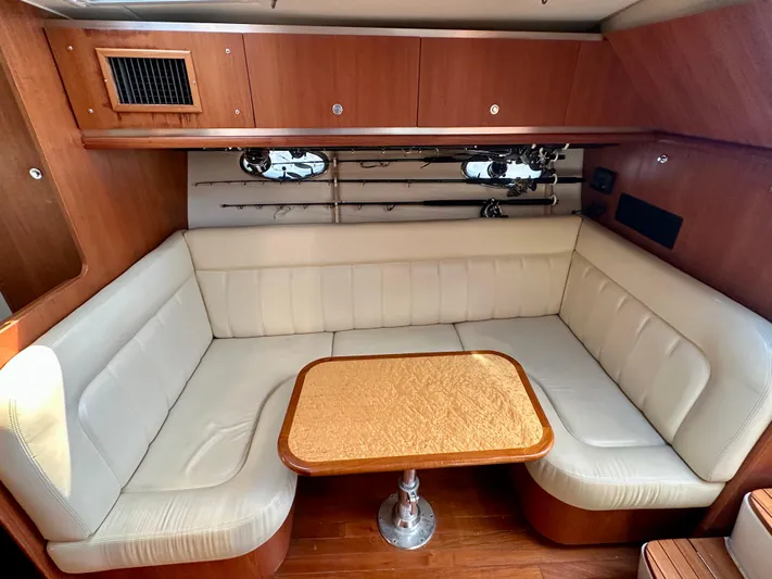  Yacht Photos Pics 2005 Tiara Yachts 3600 Open interior with cream seating and wooden table.