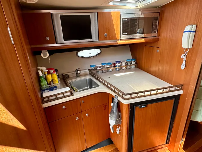  Yacht Photos Pics 2005 Tiara Yachts 3600 Open galley with microwave, sink, and storage cabinets.