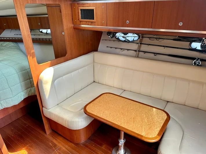  Yacht Photos Pics 2005 Tiara Yachts 3600 Open interior with cozy seating and wooden table.