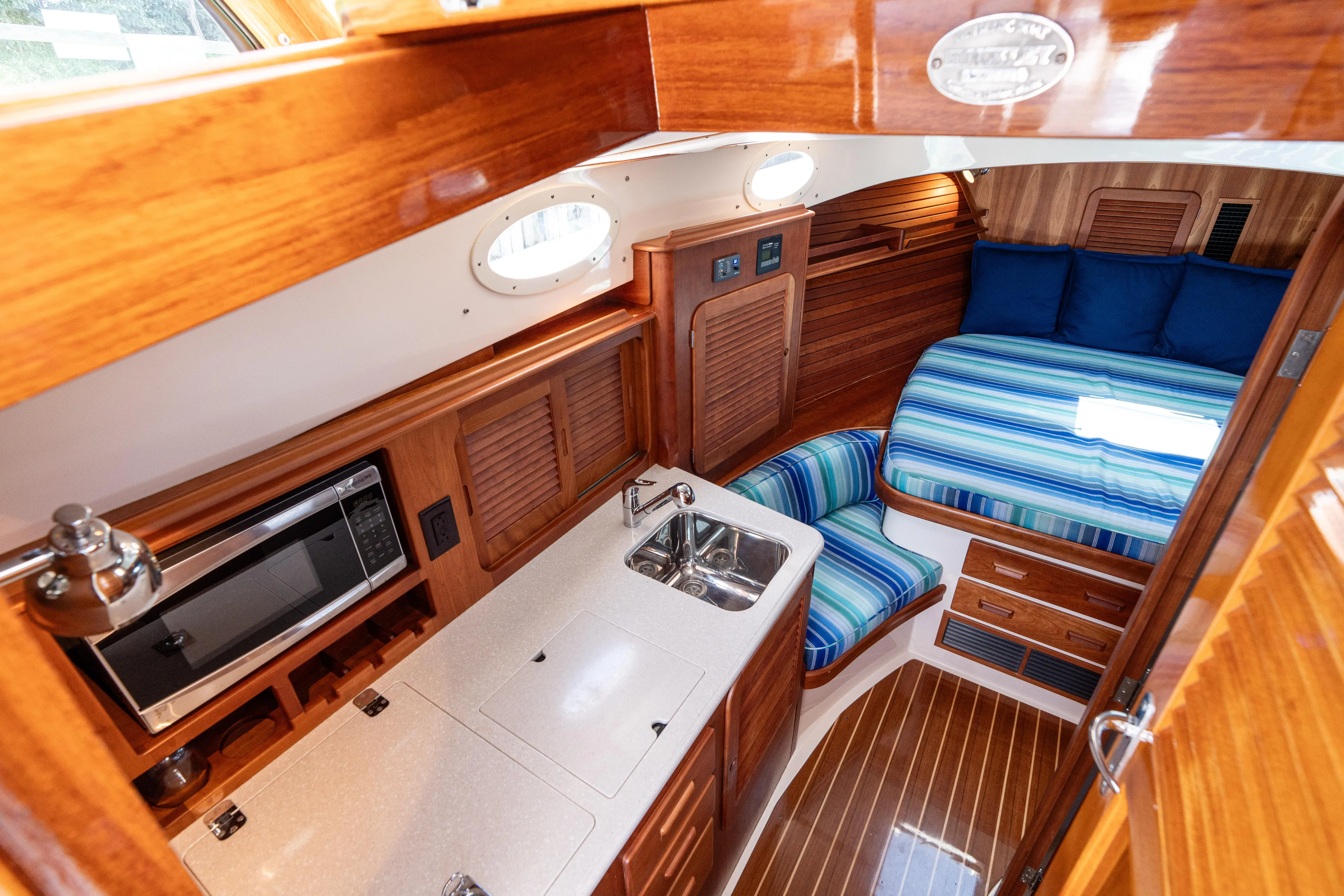 Vivere Yacht Photos Pics 2015 Hinckley Picnic Boat 37 MKIII interior with kitchenette, bed, and wooden finishes.