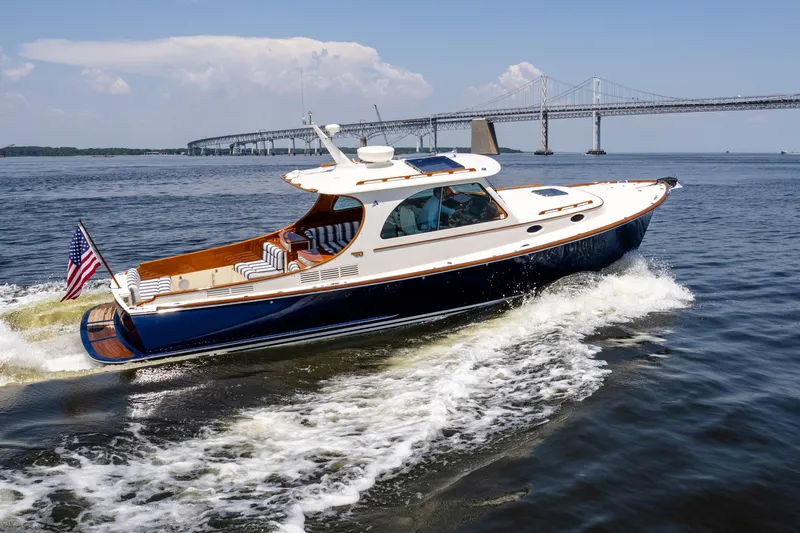 Vivere Yacht Photos Pics 2015 Hinckley Picnic Boat 37 MKIII cruising near a bridge on a sunny day.