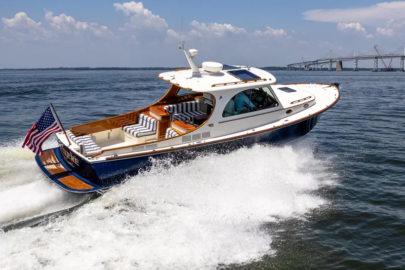 Vivere Yacht Photos Pics 2015 Hinckley Picnic Boat 37 MKIII cruising on open water, American flag displayed.