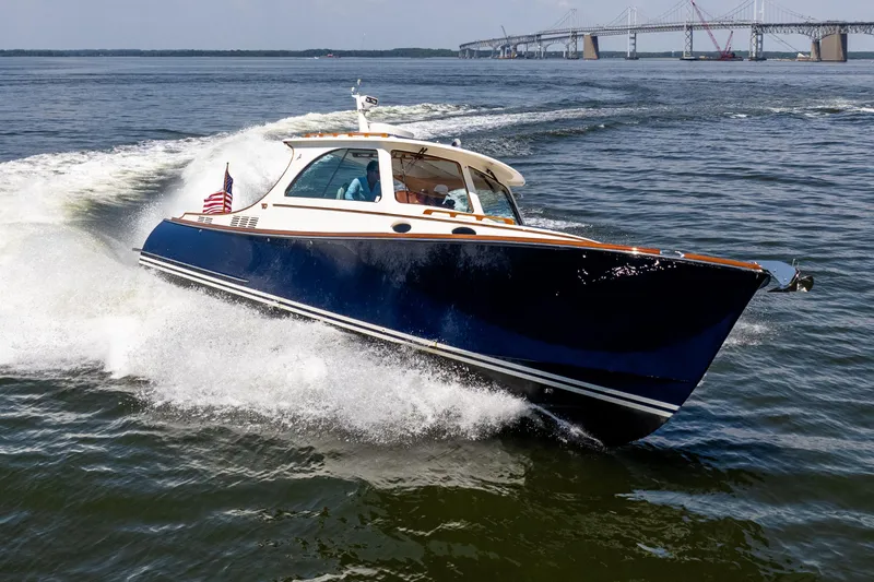 Vivere Yacht Photos Pics Hinckley Picnic Boat 37 MKIII cruising on water, 2015 model, with bridge in background.