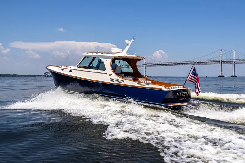Vivere Yacht Photos Pics 2015 Hinckley Picnic Boat 37 MKIII cruising near a bridge on a sunny day.