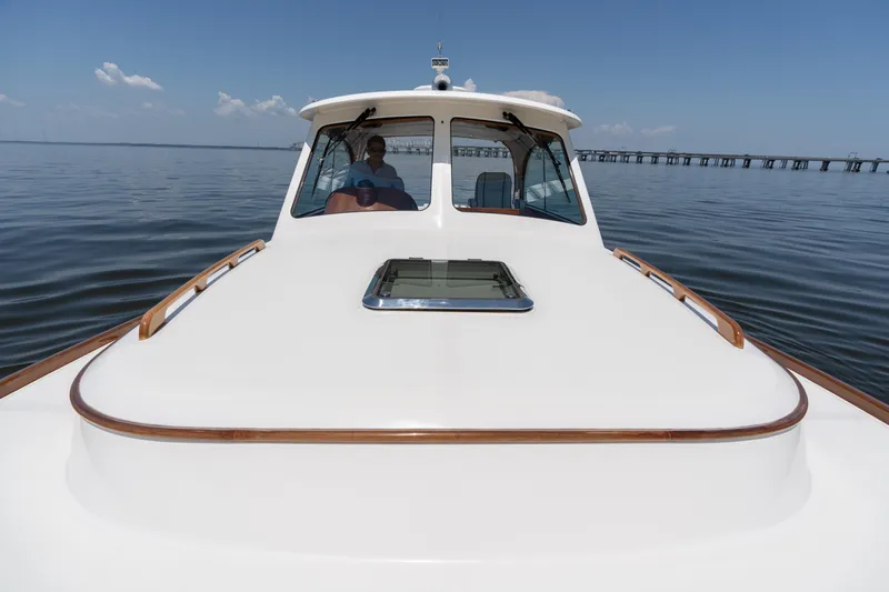Vivere Yacht Photos Pics 2015 Hinckley Picnic Boat 37 MKIII cruising on calm waters under a clear sky.