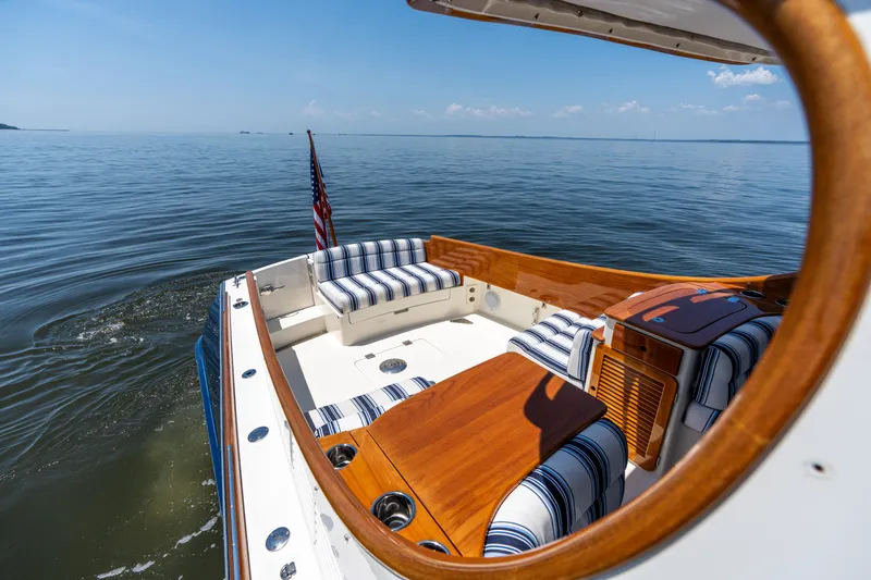 Vivere Yacht Photos Pics 2015 Hinckley Picnic Boat 37 MKIII on calm water, featuring elegant seating and wooden accents.