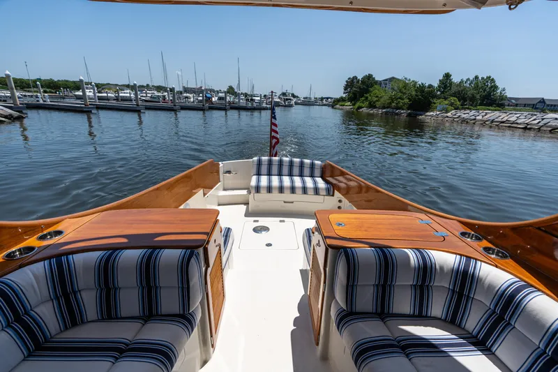 Vivere Yacht Photos Pics Hinckley Picnic Boat 37 MKIII, 2015, with striped seating, docked in a serene marina.