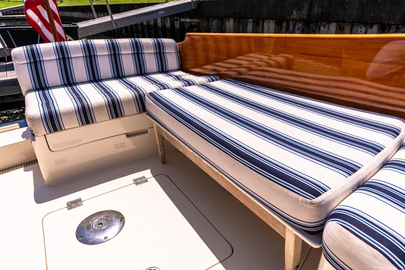 Vivere Yacht Photos Pics Striped seating on 2015 Hinckley Picnic Boat 37 MKIII deck, featuring elegant wood finish.