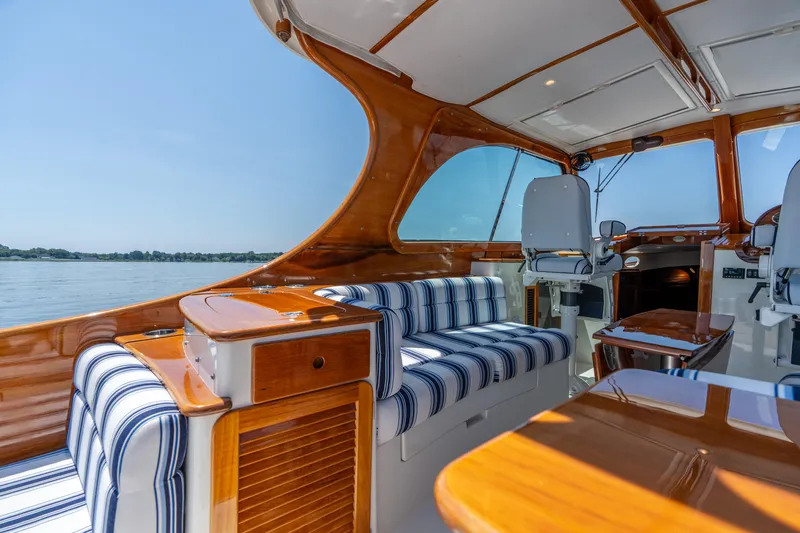 Vivere Yacht Photos Pics 2015 Hinckley Picnic Boat 37 MKIII interior with striped seating and polished wood finish.