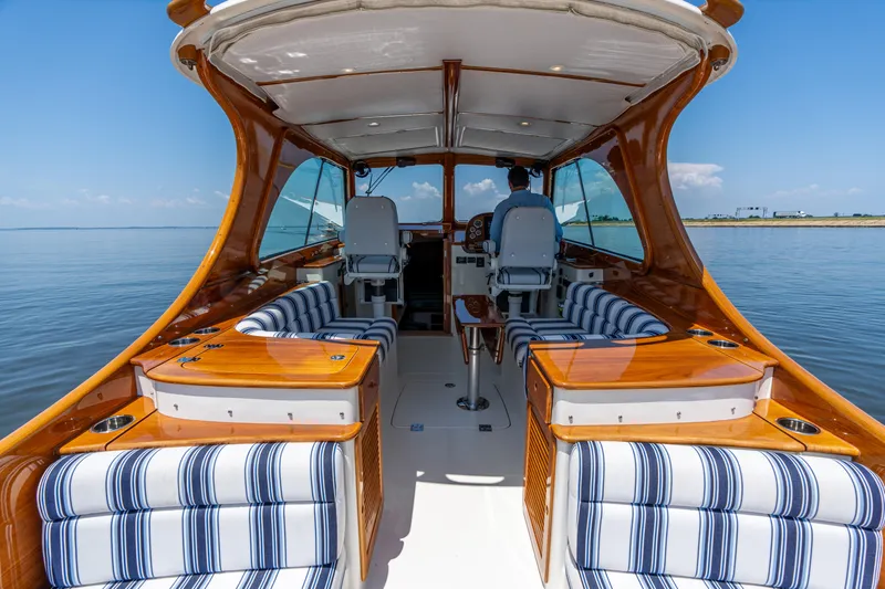 Vivere Yacht Photos Pics 2015 Hinckley Picnic Boat 37 MKIII interior with striped seating, cruising on calm waters.