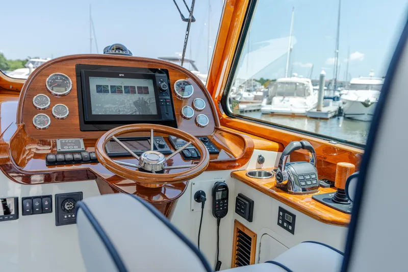 Vivere Yacht Photos Pics Helm of 2015 Hinckley Picnic Boat 37 MKIII with wooden dashboard and modern controls.