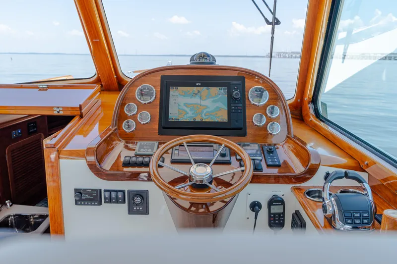 Vivere Yacht Photos Pics Helm of 2015 Hinckley Picnic Boat 37 MKIII with navigation display and wooden steering wheel.