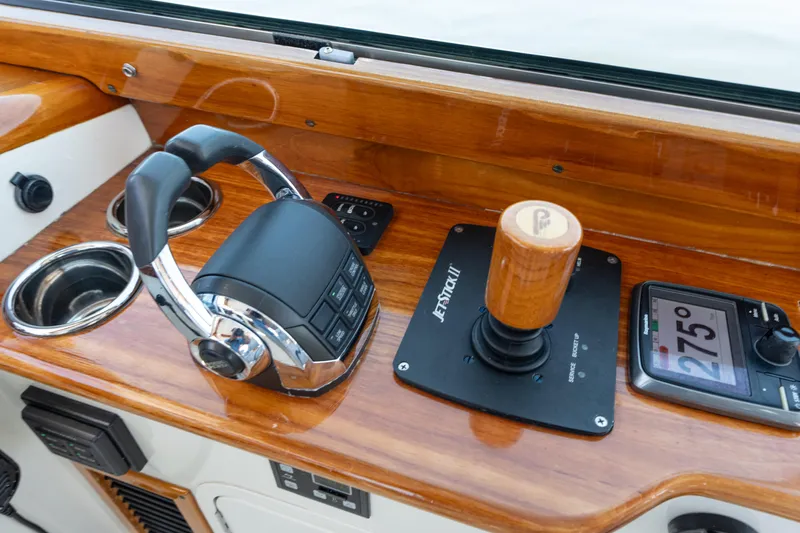 Vivere Yacht Photos Pics Control panel of 2015 Hinckley Picnic Boat 37 MKIII with joystick and navigation display.
