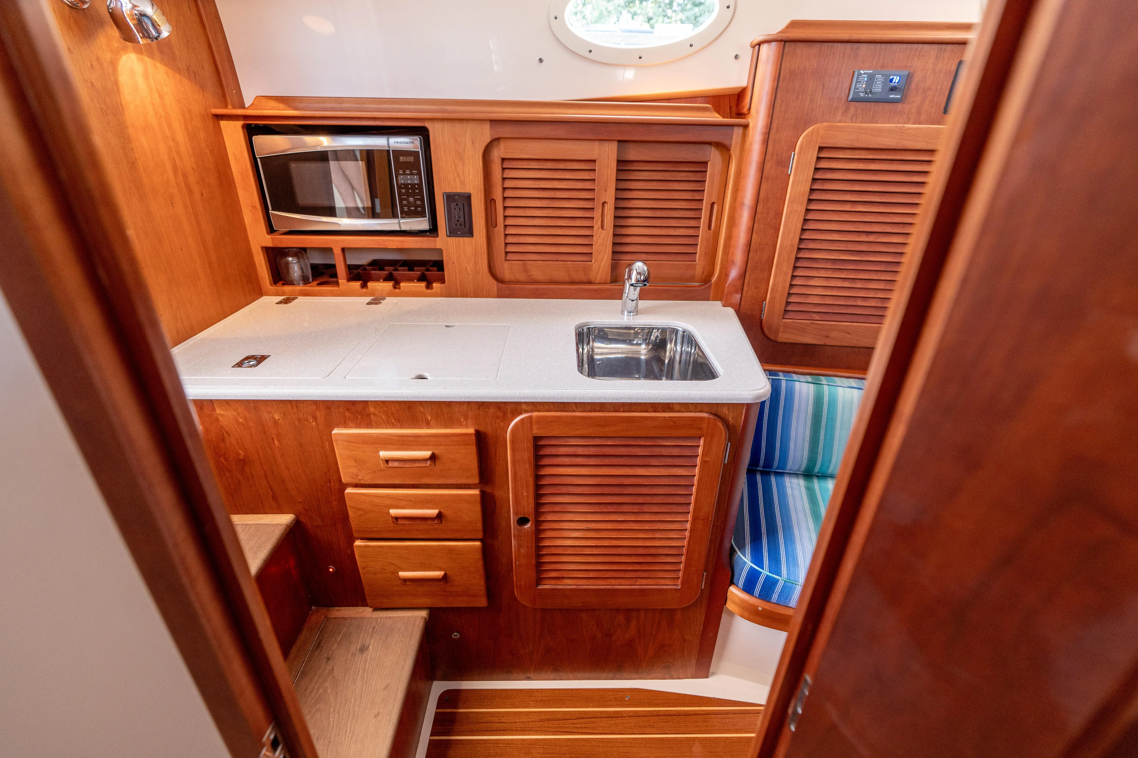 Vivere Yacht Photos Pics Hinckley Picnic Boat 37 MKIII 2015 galley with wood cabinetry, sink, and microwave.