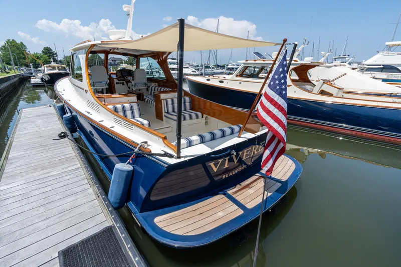 Vivere Yacht Photos Pics Hinckley Picnic Boat 37 MKIII, 2015, docked with American flag, elegant design.