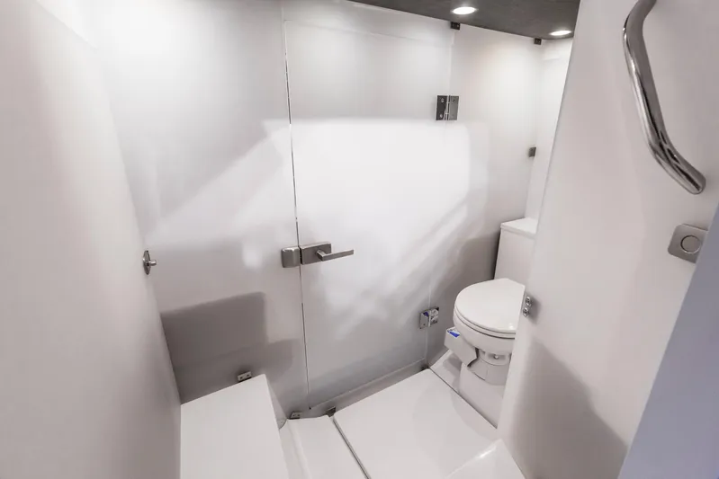  Yacht Photos Pics 2024 Axopar 37 Sun Top bathroom interior with modern white fixtures and sleek design.