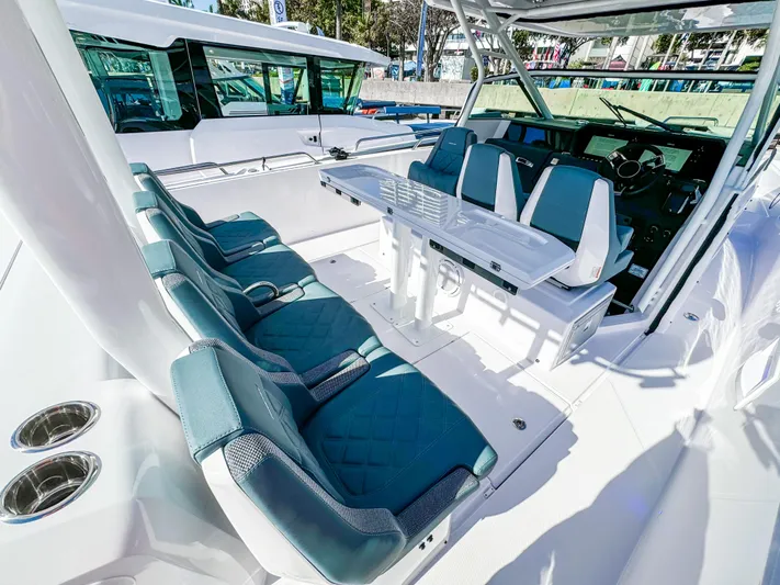  Yacht Photos Pics 2024 Axopar 37 Sun Top boat interior with teal seating and modern helm.