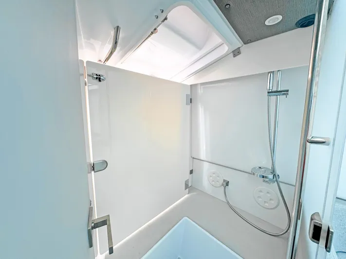  Yacht Photos Pics 2024 Axopar 37 Sun Top bathroom with modern shower and sleek design.
