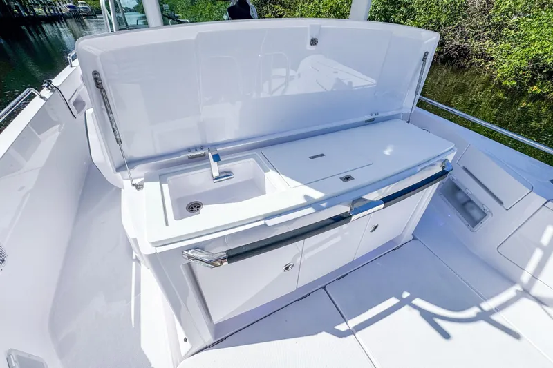  Yacht Photos Pics 2024 Axopar 37 Sun Top boat with sleek outdoor kitchen and sink.