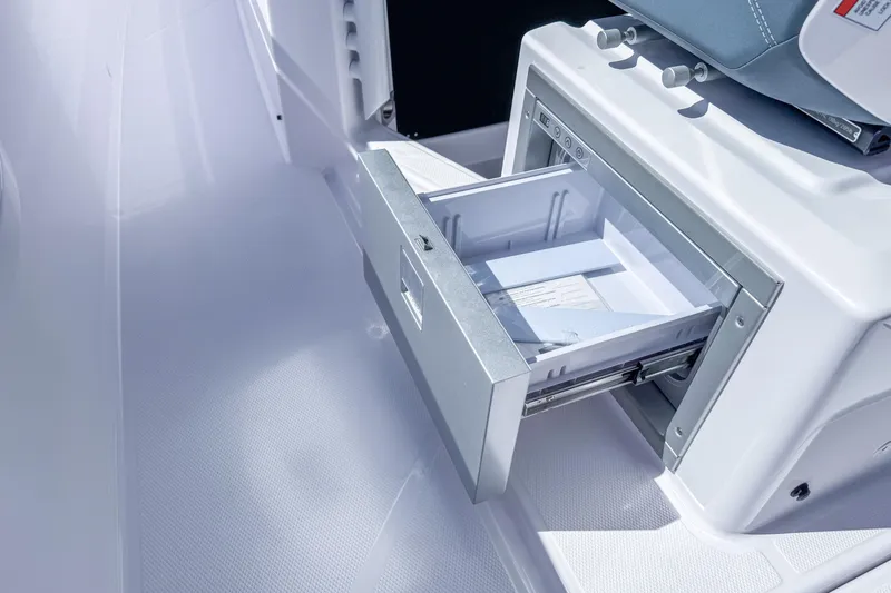  Yacht Photos Pics 2024 Axopar 37 Sun Top boat interior with open storage drawer.