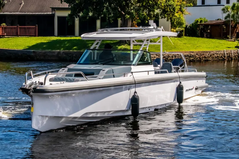  Yacht Photos Pics 2024 Axopar 37 Sun Top boat cruising on a sunny day.