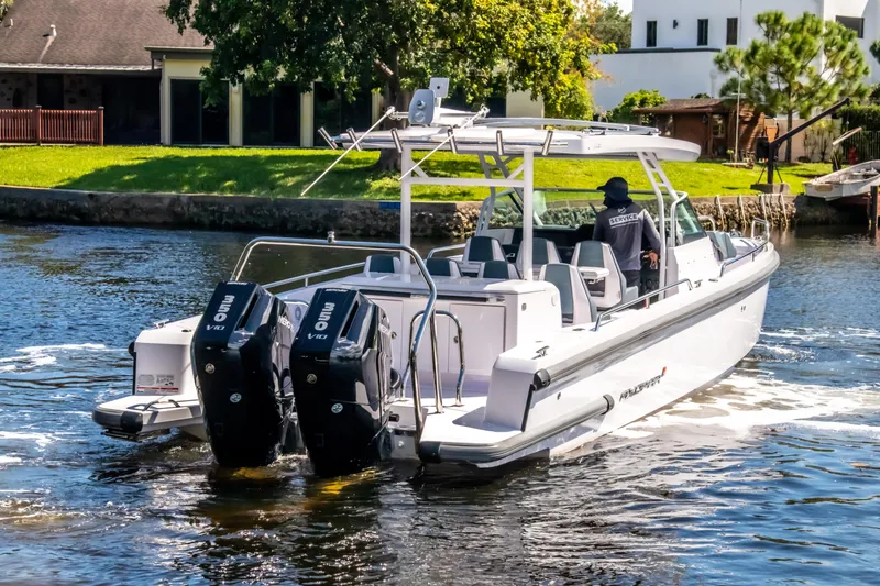  Yacht Photos Pics 2024 Axopar 37 Sun Top boat cruising on a sunny day with dual outboard engines.