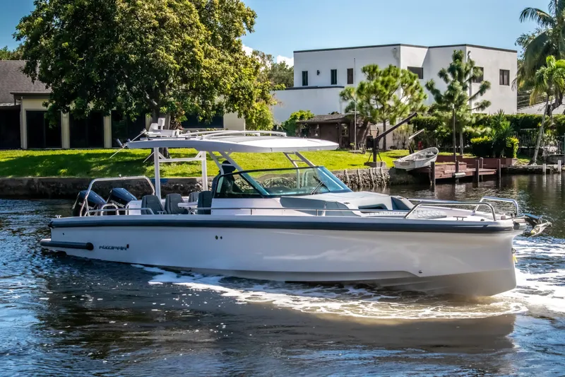  Yacht Photos Pics 2024 Axopar 37 Sun Top cruising on a scenic waterway.