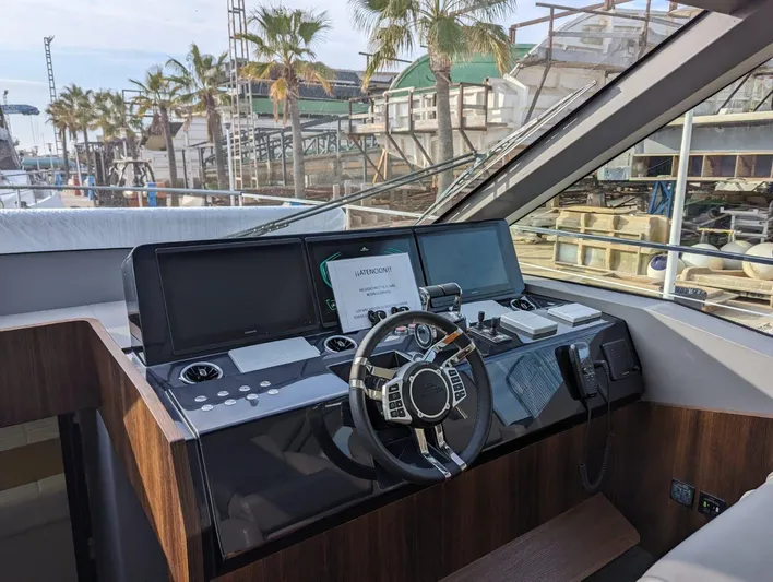  Yacht Photos Pics 2024 Astondoa AS5 yacht helm station with modern navigation equipment and steering wheel.