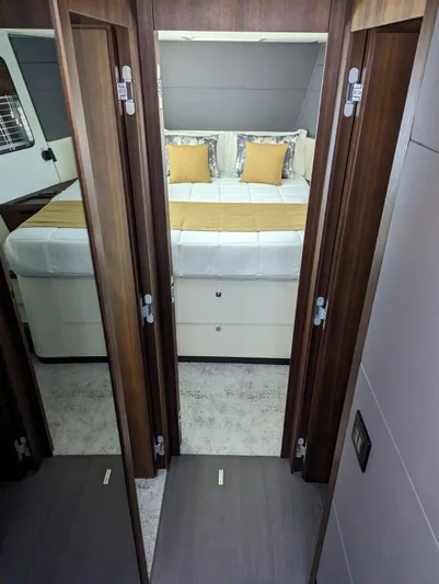  Yacht Photos Pics 2024 Astondoa AS5 yacht bedroom with double bed and wooden interior.