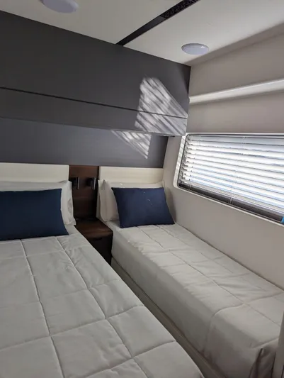  Yacht Photos Pics 2024 Astondoa AS5 yacht cabin with twin beds and modern decor.
