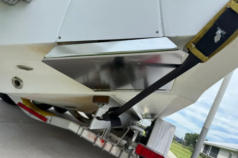  Yacht Photos Pics 2008 Contender 31 Cuddy boat on trailer, rear view with strap and metal components.