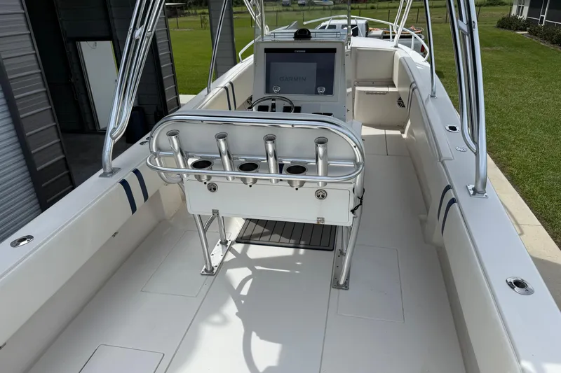  Yacht Photos Pics 2008 Contender 31 Cuddy boat interior with steering console and rod holders.