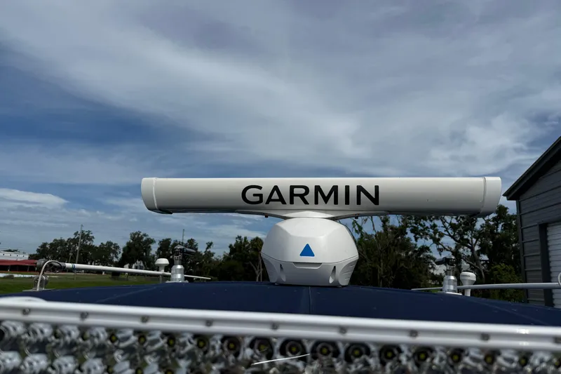  Yacht Photos Pics Garmin radar on 2008 Contender 31 Cuddy boat under a cloudy sky.