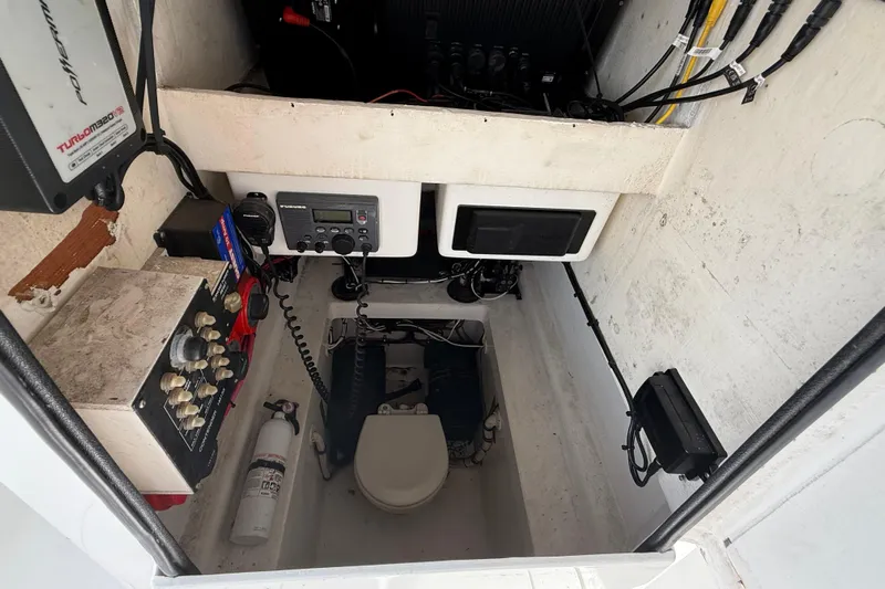  Yacht Photos Pics 2008 Contender 31 Cuddy interior with control panel, radio, and fire extinguisher.