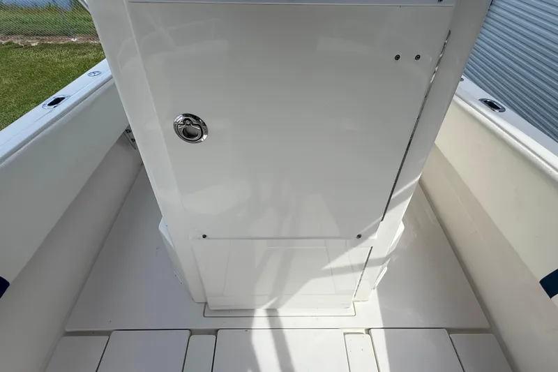  Yacht Photos Pics 2008 Contender 31 Cuddy boat interior with white storage compartment.