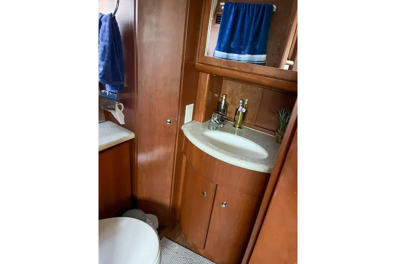  Yacht Photos Pics 2005 Silverton 39 Aft Cabin bathroom with wooden cabinetry and modern fixtures.