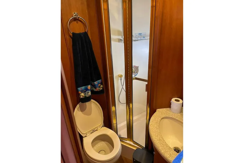  Yacht Photos Pics 2005 Silverton 39 Aft Cabin bathroom with shower, toilet, and sink.