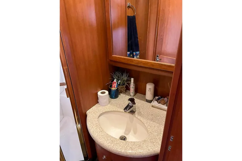  Yacht Photos Pics 2005 Silverton 39 Aft Cabin bathroom with wooden cabinetry and modern sink.