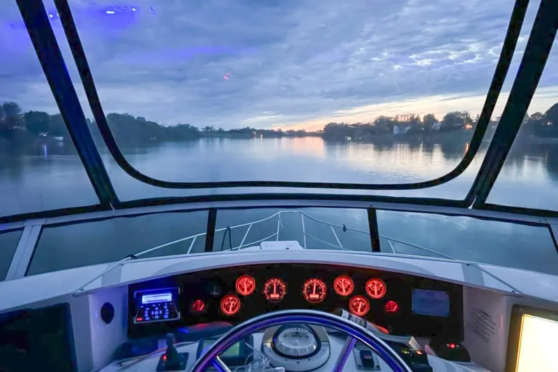  Yacht Photos Pics Cockpit view from 2005 Silverton 39 Aft Cabin yacht at sunset on a serene river.