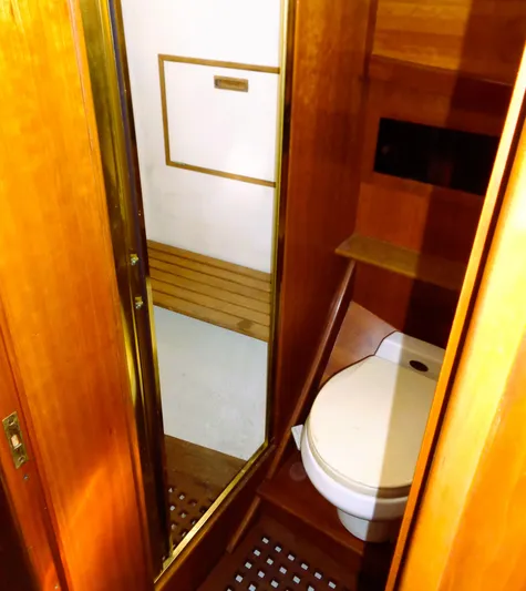 Hi Yo Silver Yacht Photos Pics 1990 Pettegrow 36 Flybridge yacht bathroom with wooden interior and compact toilet.