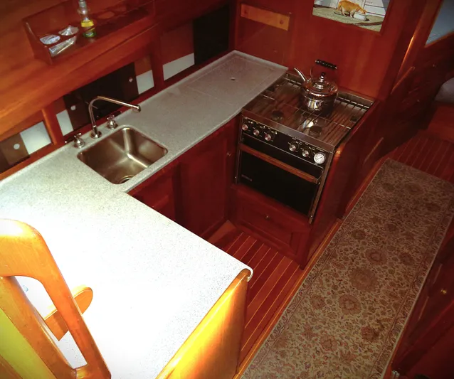 Hi Yo Silver Yacht Photos Pics Interior of 1990 Pettegrow 36 Flybridge yacht, featuring a compact kitchen with stove and sink.