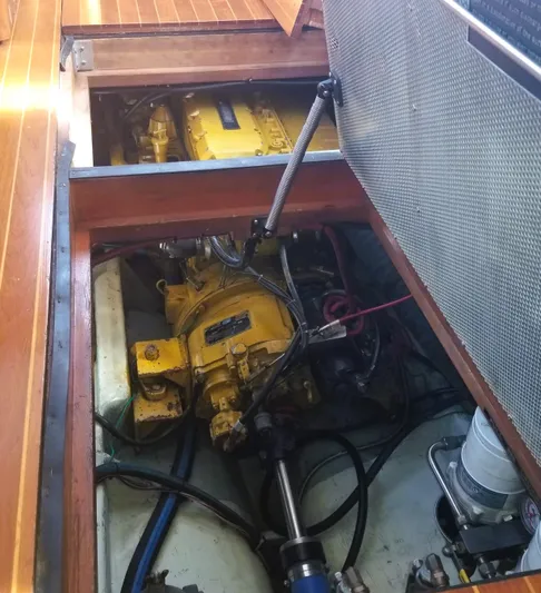 Hi Yo Silver Yacht Photos Pics Engine compartment of 1990 Pettegrow 36 Flybridge boat, showcasing yellow machinery and components.